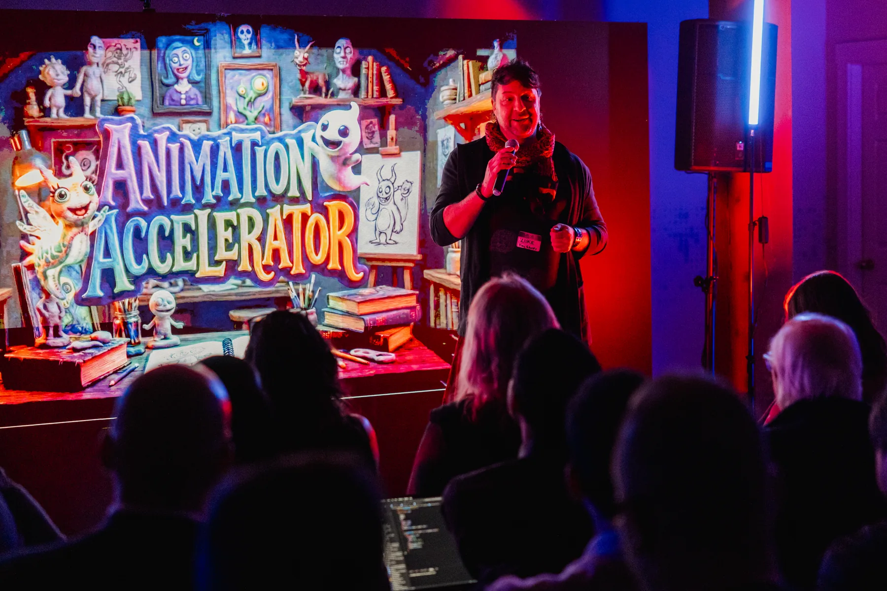 BC and AI Film Club speaker in front of creative AI visuals