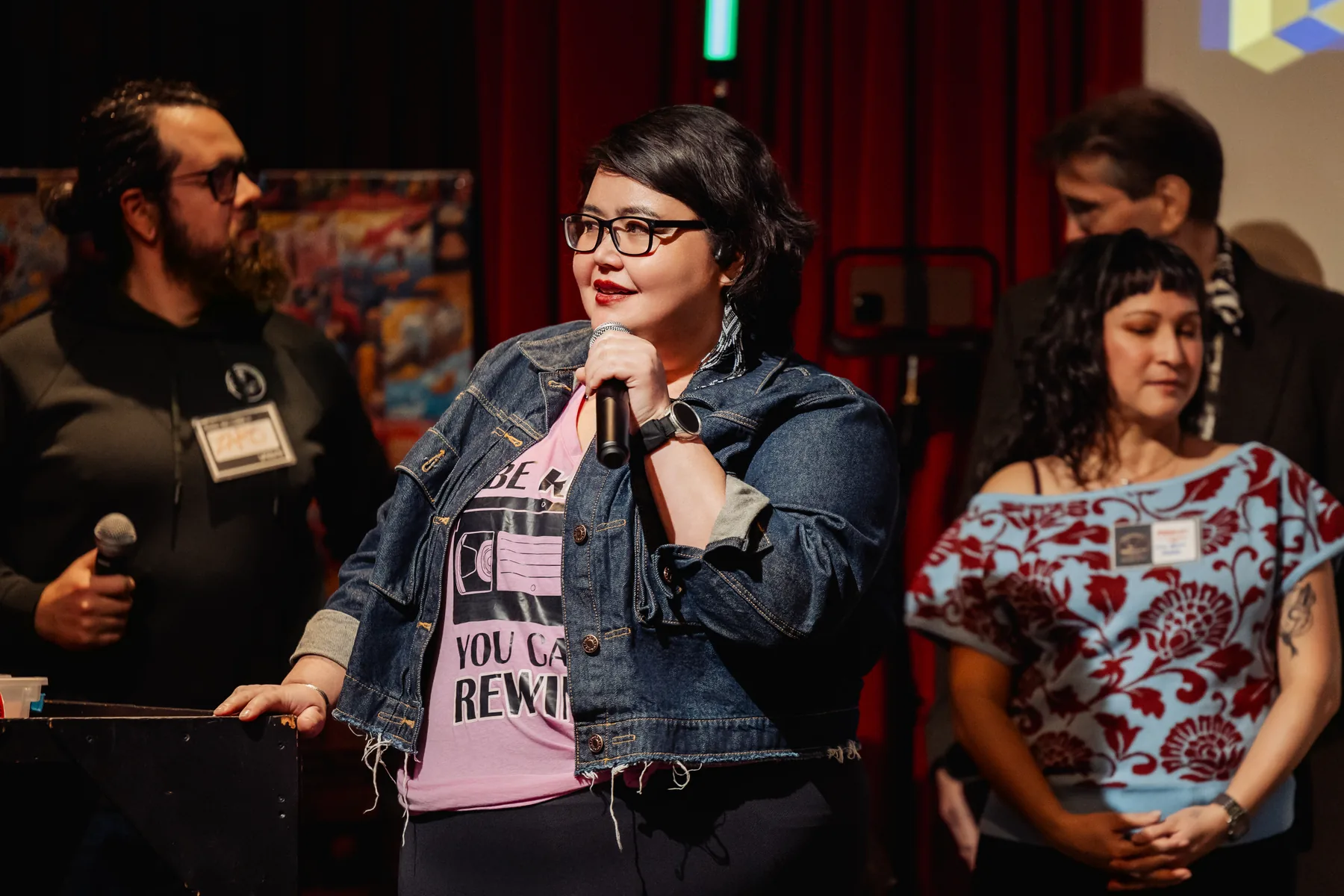 Audience member speaking into a microphone during a Vancouver AI stage moment